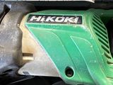 a close up of a green and black electric tool