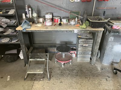 an image of a workbench in a garage with a lot of tools