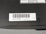 the back of a laptop with a barcode on the side of it