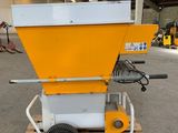 a yellow and white machine sitting on top of a wooden pallet