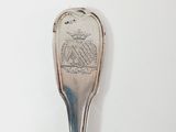 silver spoon with a silver handle with a picture of a ship on it
