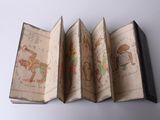 three open books with drawings on them sitting on a white surface