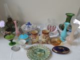a lot of glass vases and plates on the table