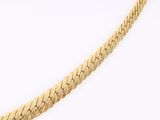 a close up of a gold chain on a white background