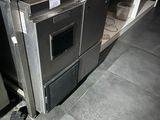 a silver oven sitting in a kitchen next to a counter