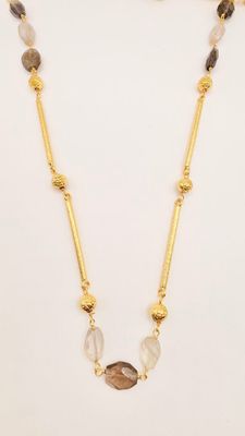the necklace is made of gold and multi colored stones