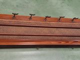 a wooden rack that has a bunch of hooks on it