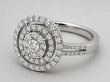 a close up of a diamond ring on a white background