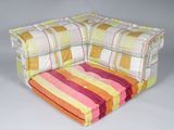 brightly colored striped chair cushion on white background with grey background