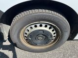 a white van with a flat tire on the side of the road