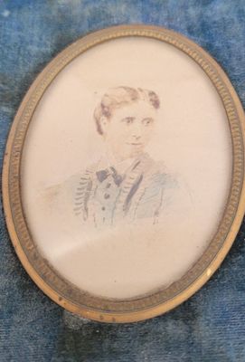 an old picture of a man in a suit and tie on a blue cloth