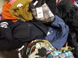 a pile of clothes that is sitting on the floor