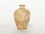 a glass vase that is sitting on a white surface