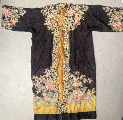 a black and yellow embroidered jacket with flowers on it