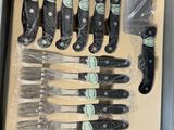 a bunch of knives that are in a box
