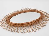 a wicker mirror on a white surface with a white background