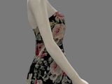 female mannequin wearing a floral dress with a black and white background