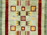 a green and red rug with geometric designs on it