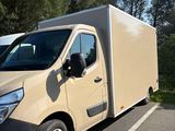 a beige van parked in a parking lot