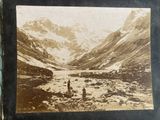 an old photo of a mountain scene with people in the foreground