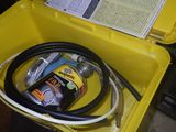 a yellow box that has a hose in it