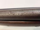 a close up of a gun on a table with a white background