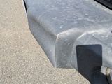 a close up of a car ' s bumper with a number plate on it