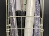 many rolls of wrapping sitting in a wire basket
