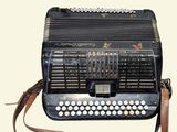 a black accordion sitting on top of a white table