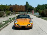 a yellow car that is parked on the side of the road