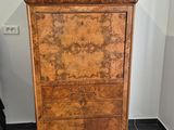 a wooden cabinet with a marble top in a room