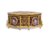 a gold and blue box on a stand on a white surface