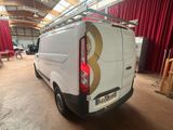 a van that is parked in a building with red curtains
