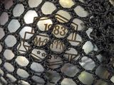 a close up of a person holding a mesh bag with a coin inside of it