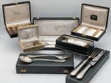 several silverware items including a spoon, fork and spoon rest
