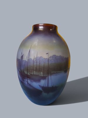 a vase with a painting of boats on it