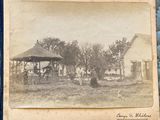 an old black and white photo of a gazebo in a yard
