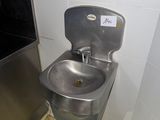 a sink and a trash can in a small room