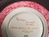 two plates with writing on them sitting on a table