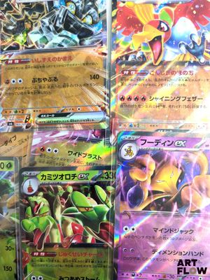 several pokemon cards are stacked on top of each other on a table