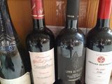 several bottles of wine are lined up in a row on a table