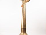 an image of a brass clock on a wooden stand on a white background