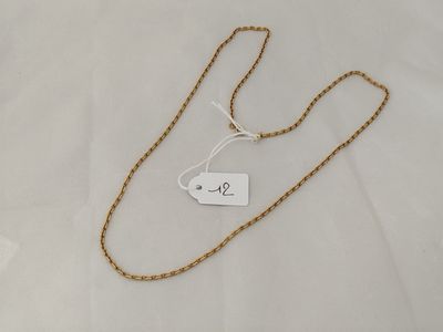 a close up of a gold chain with a price tag on it