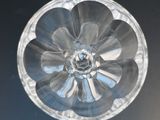a clear glass bowl with a flower inside of it