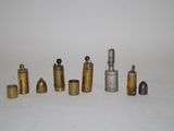 many different types of brass pipes on a white surface