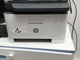 a printer sitting on top of a desk next to a computer