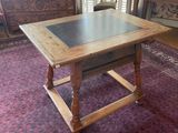 a wooden table with a slate top in a room