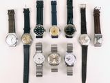 a lot of watches that are sitting on a table