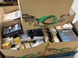 a cardboard box full of electronic equipment in a room