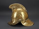 an antique gold helmet on a black background
